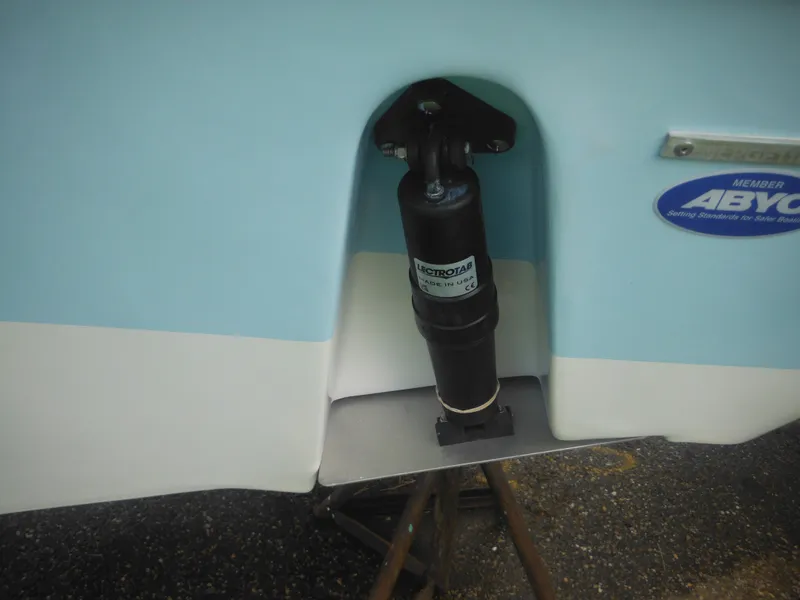 Slide: The Image of 2024 Tidewater 220 LXF boat transom with trim tab actuator. - 12