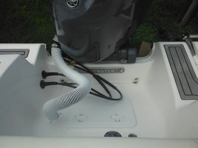 Slide: The Image of 2024 Tidewater 220 LXF boat engine compartment with hoses and wiring. - 16