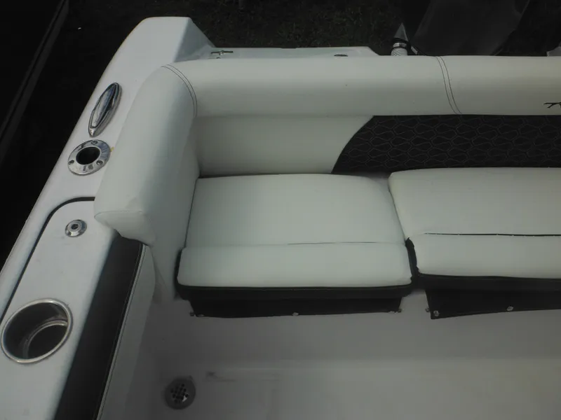 Slide: The Image of 2024 Tidewater 220 LXF boat seating area with cup holder and storage. - 19