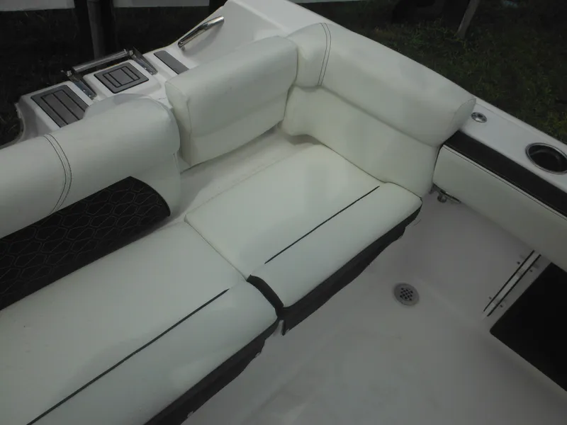 Slide: The Image of 2024 Tidewater 220 LXF boat interior with white cushioned seating. - 21
