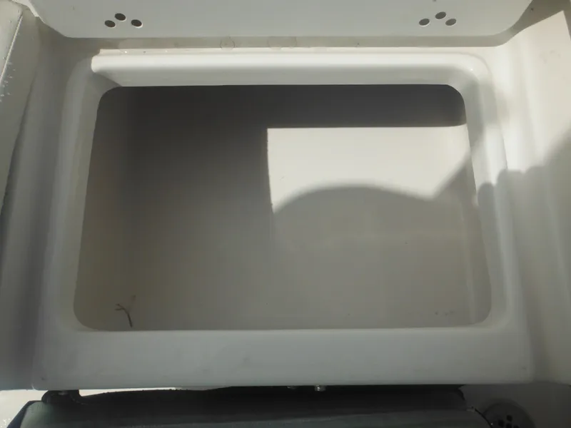 Slide: The Image of 2024 Tidewater 220 LXF storage compartment, open and empty. - 23