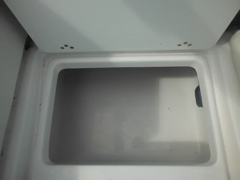 Slide: The Image of 2024 Tidewater 220 LXF storage compartment, open and empty. - 25
