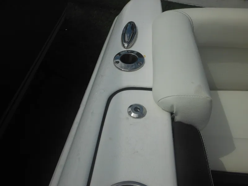 Slide: The Image of Close-up of 2024 Tidewater 220 LXF boat's white leather seating and cup holder. - 26