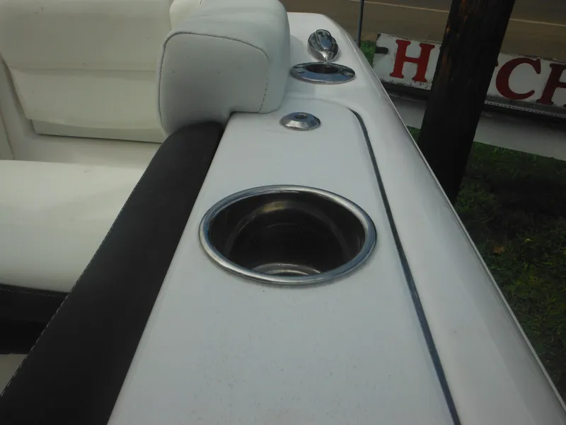Slide: The Image of 2024 Tidewater 220 LXF boat interior with cup holders and white seating. - 28