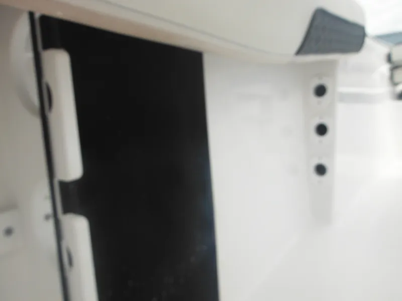 Slide: The Image of Close-up of 2024 Tidewater 220 LXF boat hinge and fittings. - 30