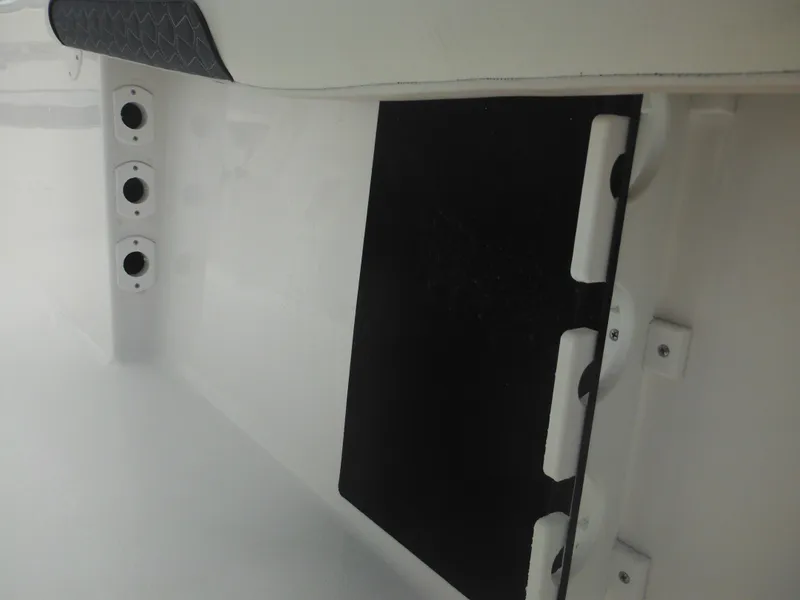 Slide: The Image of 2024 Tidewater 220 LXF boat interior detail with rod holders and storage compartment. - 31