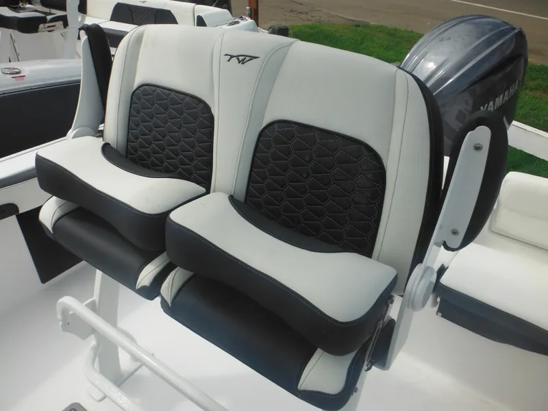 Slide: The Image of 2024 Tidewater 220 LXF boat seats with black and white upholstery. - 34