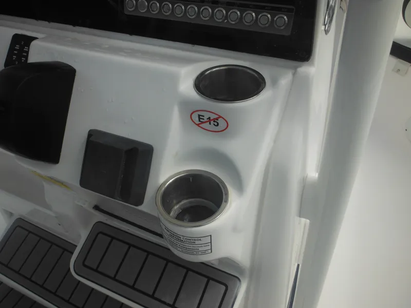 Slide: The Image of 2024 Tidewater 220 LXF boat console with cup holders and control panel. - 46