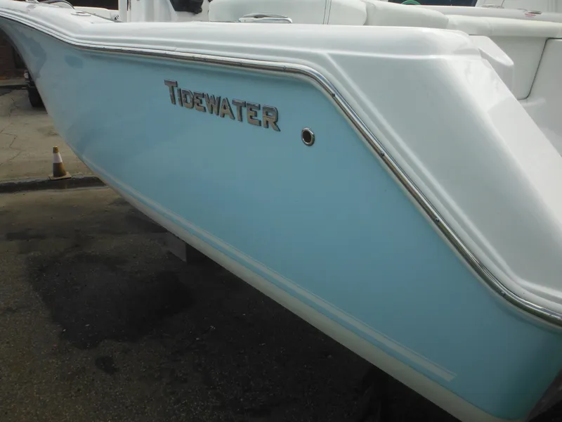 Slide: The Image of 2024 Tidewater 220 LXF boat, light blue hull, side view. - 6