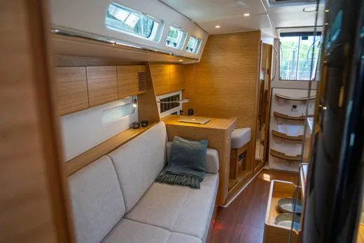 Slide: The Image of 2024 X-Yachts X4-0 interior, modern yacht cabin with sofa and wooden finishes. - 13