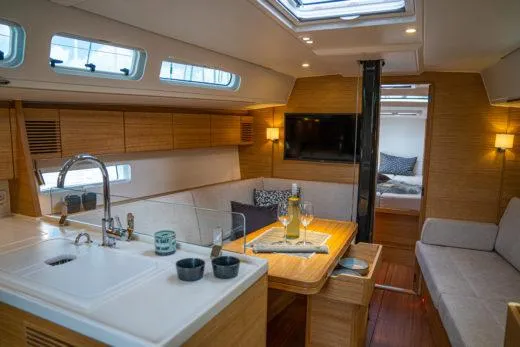 Slide: The Image of Luxurious interior of 2024 X-Yachts X4-0 sailboat with modern kitchen and cozy seating area. - 14