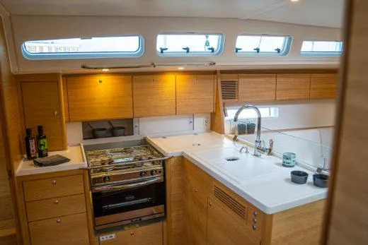 Slide: The Image of Modern kitchen in 2024 X-Yachts X4-0 sailboat with wooden cabinetry and stainless steel appliances. - 15