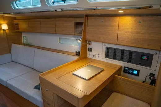 Slide: The Image of Modern interior of 2024 X-Yachts X4-0 with wooden finishes and a cozy seating area. - 16