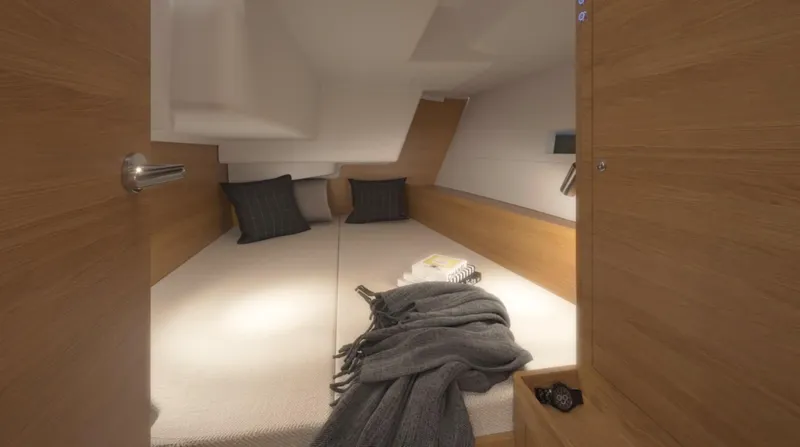 Slide: The Image of 2024 X-Yachts X4-0 cabin interior with cozy bedding and wooden finish. - 19
