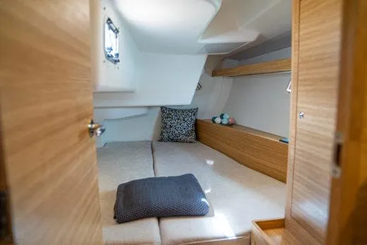 Slide: The Image of 2024 X-Yachts X4-0 cabin interior with cozy bedding and wooden finishes. - 20