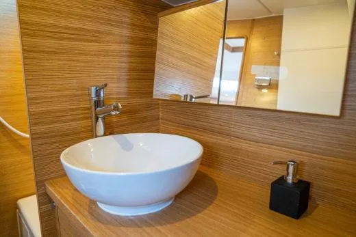Slide: The Image of Modern bathroom sink in 2024 X-Yachts X4-0 yacht with wooden finish. - 23