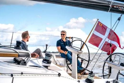 Slide: The Image of Two people sailing on a 2024 X-Yachts X4-0 yacht with a Danish flag. - 7
