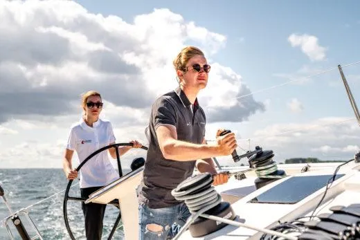 Slide: The Image of Sailing the 2024 X-Yachts X4-0 on a sunny day with two people at the helm. - 8