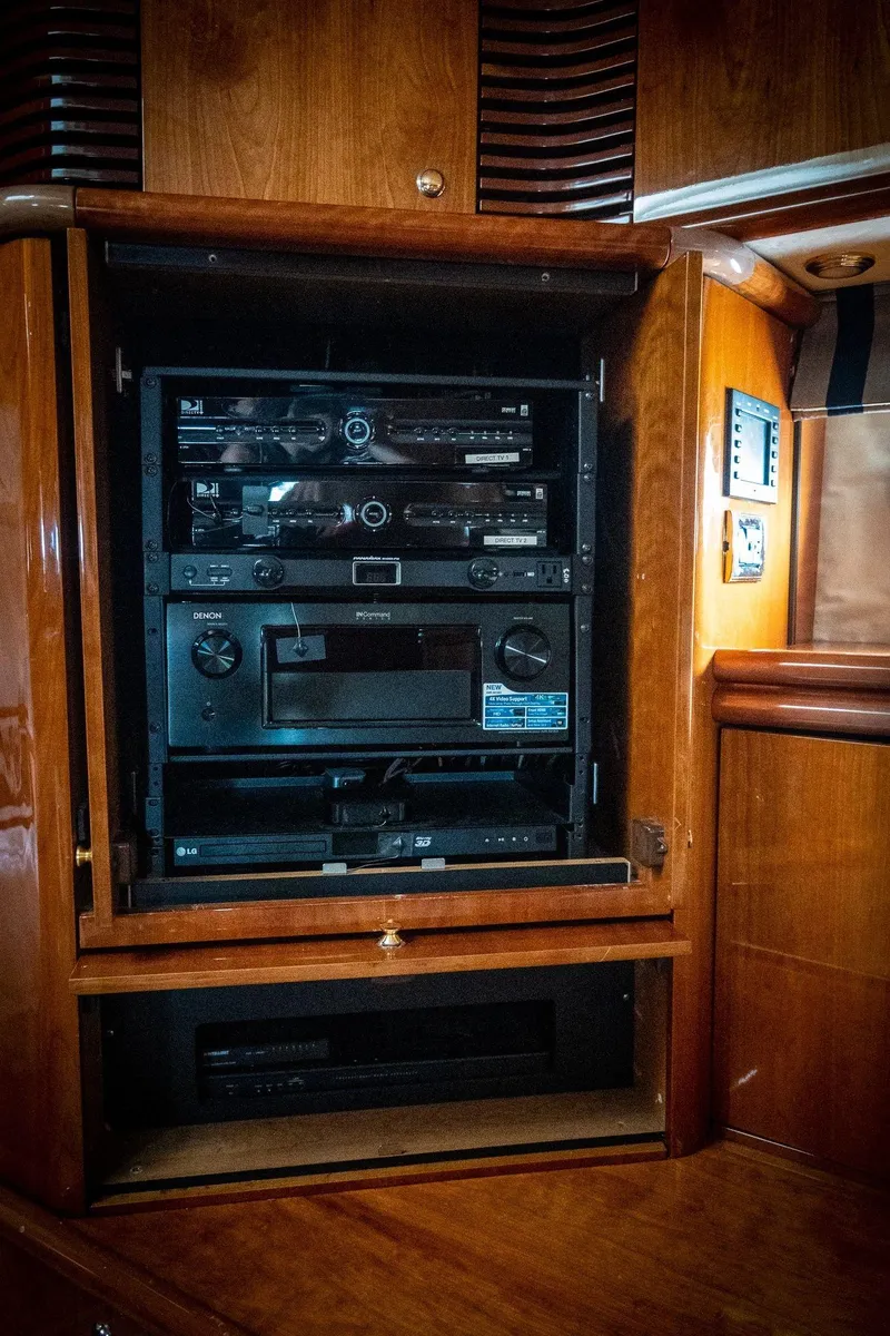 Slide: The Image of Luxurious interior of a 1998 Sunseeker Predator 63 yacht with white seating and wooden flooring. - 10