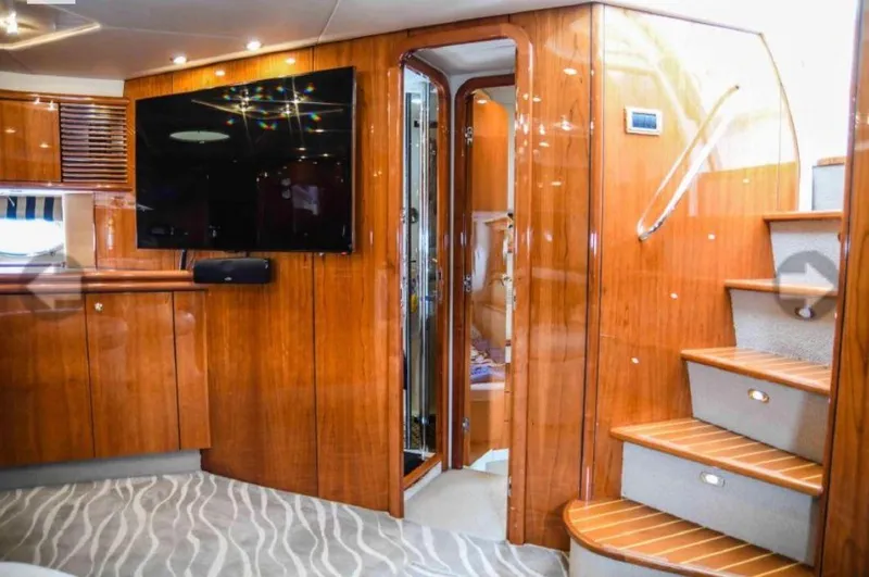 Slide: The Image of Interior of 1998 Sunseeker Predator 63 yacht with white seating and marina view. - 15