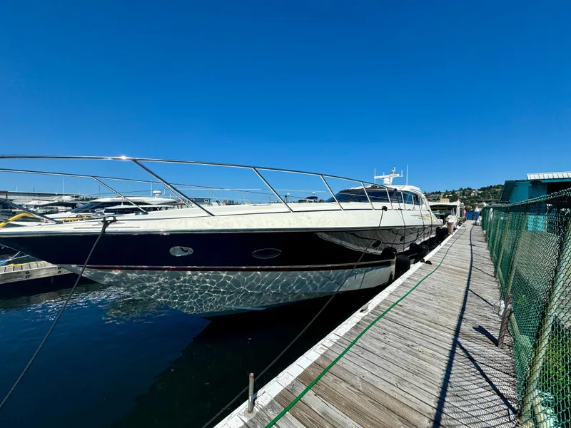 Slide: The Image of 1998 Sunseeker Predator 63 yacht docked at marina, clear blue sky background. - 2