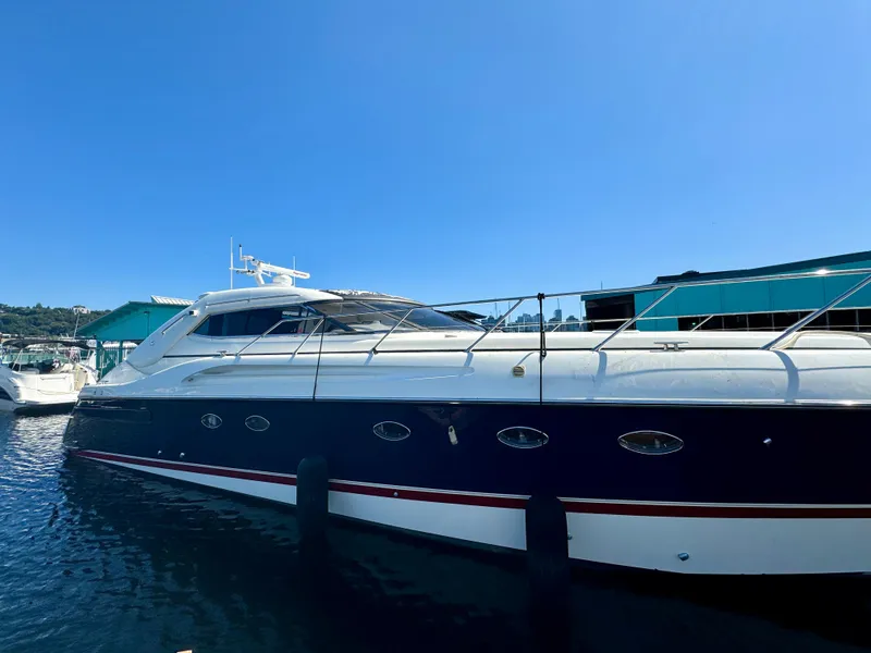 Slide: The Image of 1998 Sunseeker Predator 63 yacht docked at marina under clear blue sky. - 7