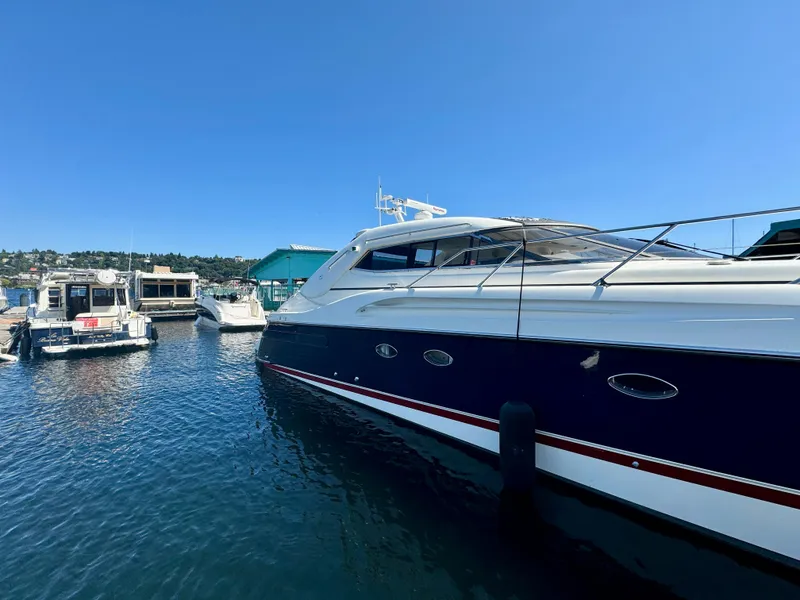 Slide: The Image of Luxurious interior of a 1998 Sunseeker Predator 63 yacht with white seating and table. - 8