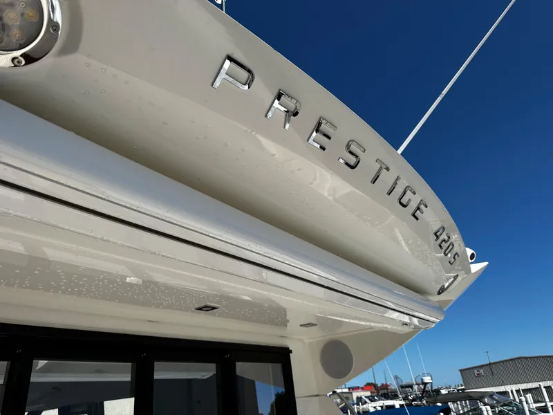 Slide: The Image of 2024 Prestige 420S yacht at a marina under clear blue sky. - 14