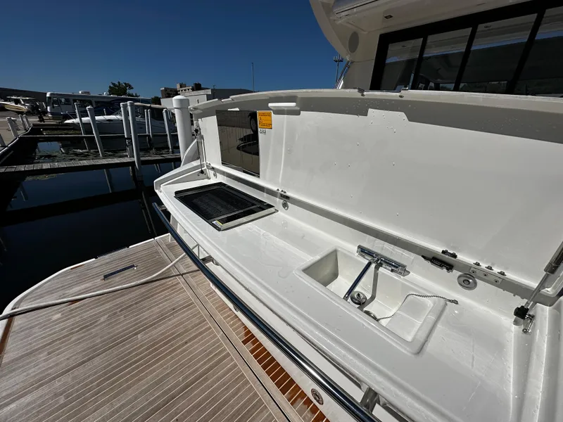 Slide: The Image of Prestige 420S 2024 yacht with open deck storage and sink at marina. - 16