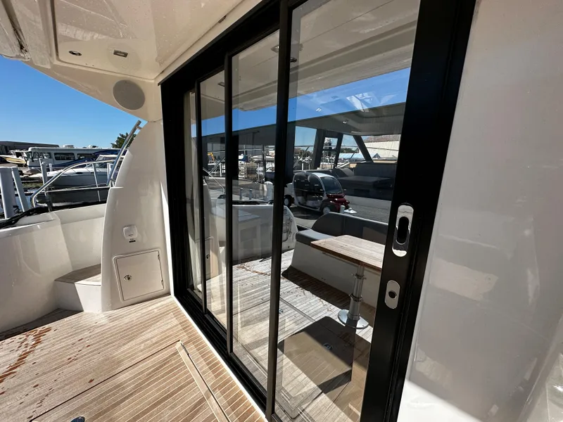 Slide: The Image of 2024 Prestige 420S yacht with sliding glass doors and teak deck. - 23
