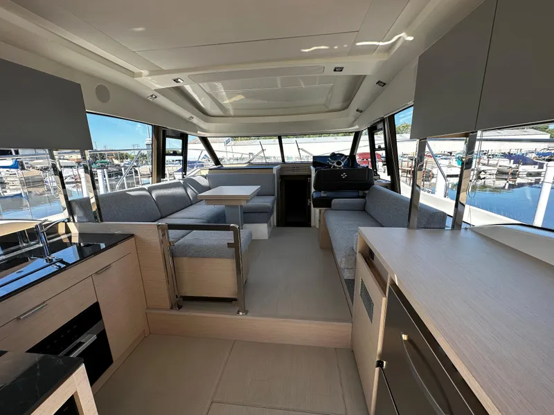 Slide: The Image of Interior of 2024 Prestige 420S yacht with modern furnishings and marina view. - 24
