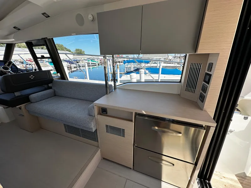 Slide: The Image of Interior of 2024 Prestige 420S yacht with modern kitchen and seating area. - 25