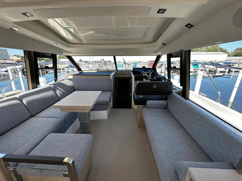 Slide: The Image of Interior of 2024 Prestige 420S yacht with modern seating and panoramic windows. - 26