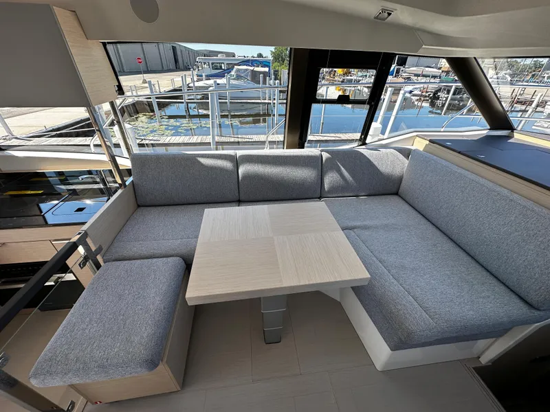 Slide: The Image of Modern interior of 2024 Prestige 420S yacht with grey seating and wooden table. - 29