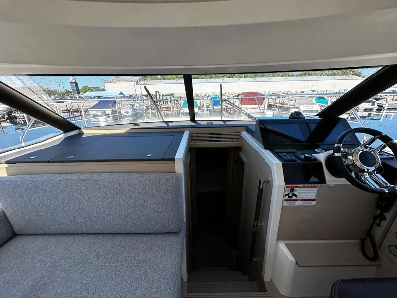 Slide: The Image of Interior cockpit of 2024 Prestige 420S yacht with modern controls and seating. - 30