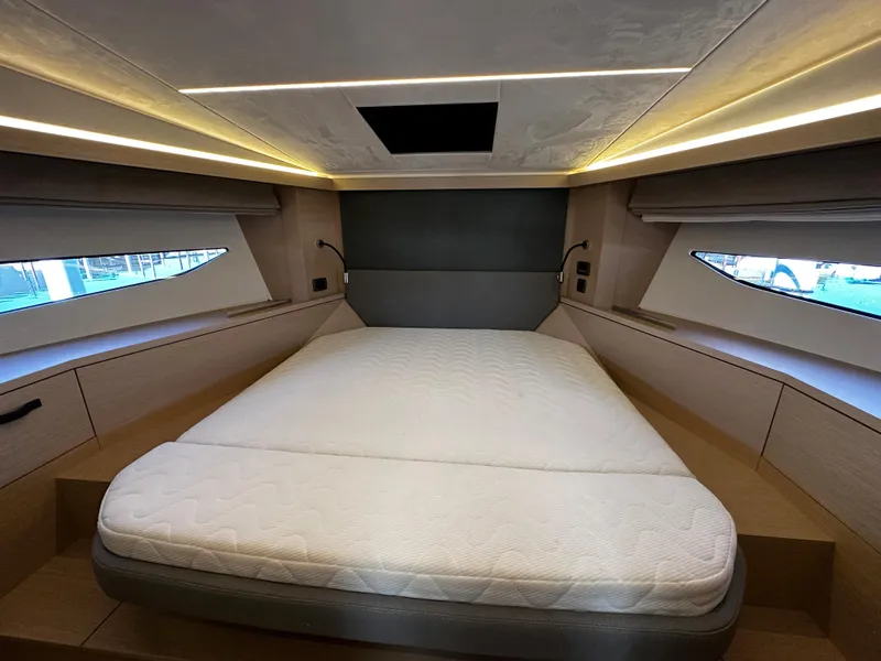 Slide: The Image of Luxurious bedroom interior of 2024 Prestige 420S yacht with modern lighting and large windows. - 37