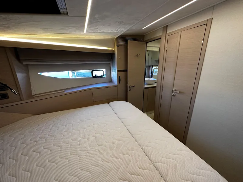 Slide: The Image of Prestige 420S 2024 yacht interior bedroom with modern design and natural light. - 38