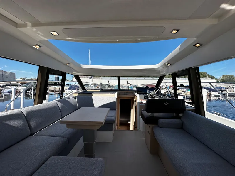 Slide: The Image of 2024 Prestige 420S yacht interior with panoramic windows and modern seating. - 48