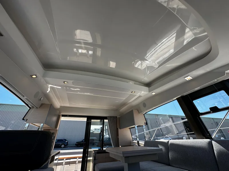 Slide: The Image of Interior of 2024 Prestige 420S yacht with modern seating and large windows. - 49