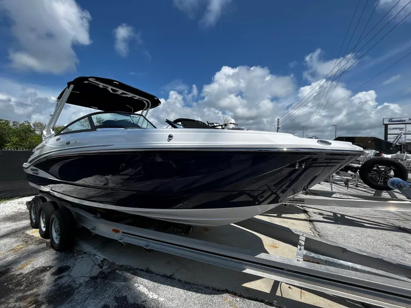 Slide: The Image of 2024 Monterey M-65 boat on a trailer under a blue sky. - 0