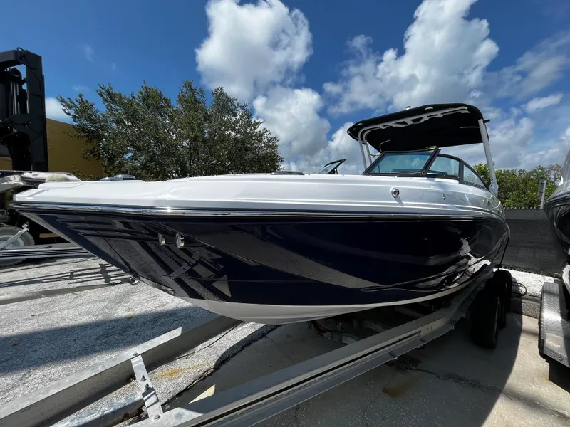 Slide: The Image of 2024 Monterey M-65 boat on trailer under blue sky. - 1