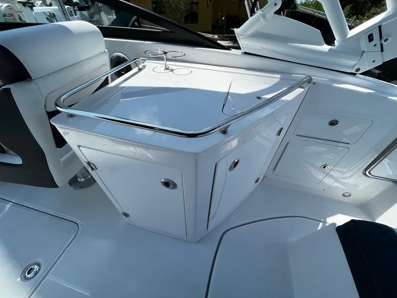 Slide: The Image of 2024 Monterey M-65 boat interior with white seating and storage compartments. - 10