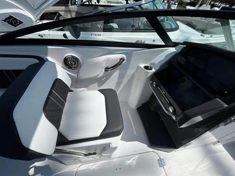Slide: The Image of 2024 Monterey M-65 boat interior with black and white seating and dashboard. - 13