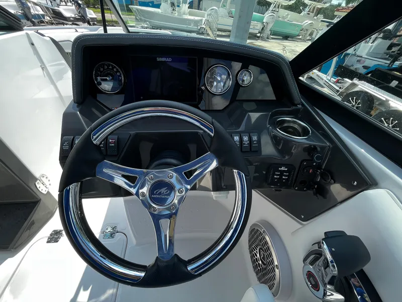 Slide: The Image of 2024 Monterey M-65 boat dashboard with steering wheel, gauges, and controls. - 15