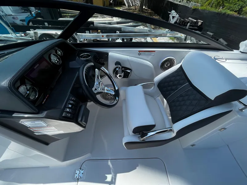 Slide: The Image of 2024 Monterey M-65 boat cockpit with modern steering wheel and luxurious seating. - 16
