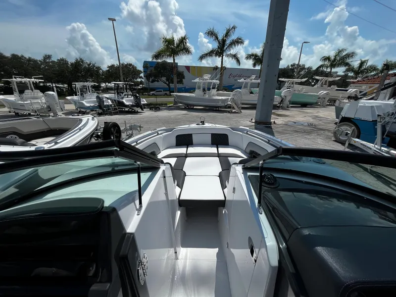 Slide: The Image of 2024 Monterey M-65 boat interior at a marina with other boats and palm trees. - 17