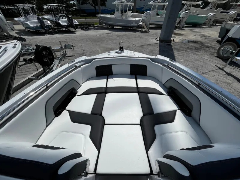 Slide: The Image of 2024 Monterey M-65 boat with spacious, cushioned seating area. - 18