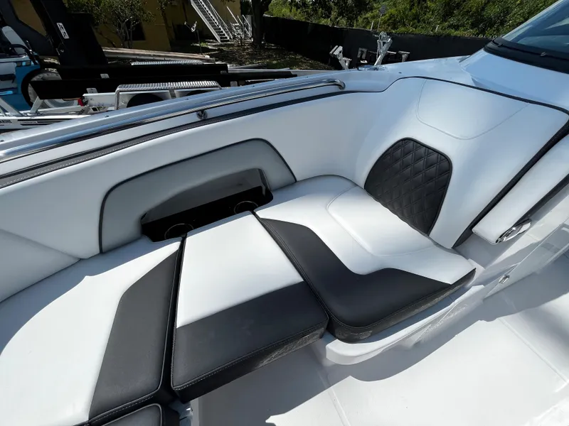 Slide: The Image of 2024 Monterey M-65 boat interior with white and black cushioned seating. - 20
