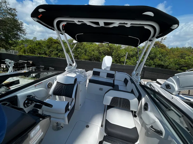 Slide: The Image of 2024 Monterey M-65 boat interior with seating and canopy, outdoor setting. - 22