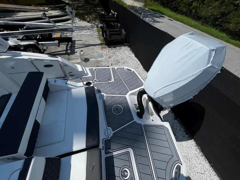 Slide: The Image of 2024 Monterey M-65 boat with covered outboard motor and cushioned seating. - 4